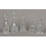 Three cut lead crystal glass decanters Each with facet and floral cut decorations;