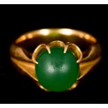 An unmarked gold and jade ring Set with a single jade cabochon.