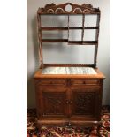 A 19th century Chinese carved hardwood side cabinet The pierced galleried shelf section above the
