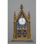 An enamel decorated gilt bronze, probably Russian, desk clock Of Gothic Revival architectural form,
