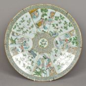 A Chinese famille verte porcelain charger Decorated with figural vignettes interspersed with birds