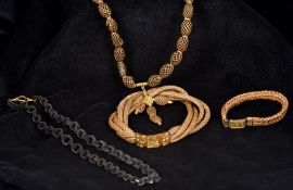 Four pieces of Victorian unmarked yellow metal mounted hair plait mourning jewellery Comprising: a