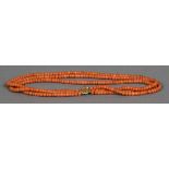 A three strand coral bead necklace Set with a gold clasp. Approximately 47 cm long.