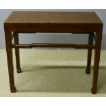 A 19th century Chinese elm table The panelled rectangular top above the tapering square section