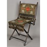 A 19th century Turkish folding chair With painted and stitched decorations. 44 cm wide.