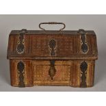 A tooled leather casket The hinged lid of canted domed rectangular form with cast anthemion metal