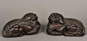 A pair of Chinese carved wooden models of dogs-of-fo Each modelled recumbent, one with a ball,