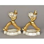 A pair of Continental Art Deco candlesticks Each of figural form with gilt decorations.
