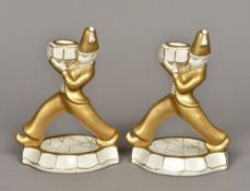 A pair of Continental Art Deco candlesticks Each of figural form with gilt decorations.