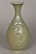 A Chinse porcelain baluster vase With relief carved dragon decoration and allover celadon glaze.