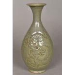 A Chinse porcelain baluster vase With relief carved dragon decoration and allover celadon glaze.