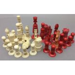 A 19th century carved and stained ivory chess set The King 9.5 cm high.