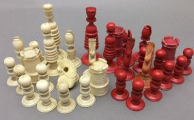 A 19th century carved and stained ivory chess set The King 9.5 cm high.