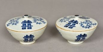 A pair of Chinese blue and white porcelain bowls and covers Each decorated with foliate scrolls