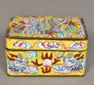 A Canton enamel box Of hinged rectangular form, decorated with dragons on a yellow ground. 10.