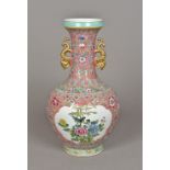 A Chinese porcelain twin handled baluster vase Decorated with birds in floral spray vignettes,