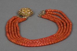A five string coral bead necklace Set with a pierced gold clasp. Approximately 43 cm long.