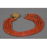 A five string coral bead necklace Set with a pierced gold clasp. Approximately 43 cm long.