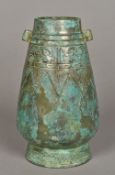 A Chinese Shang dynasty style hu shaped bronze vase With twin lug handles,