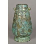 A Chinese Shang dynasty style hu shaped bronze vase With twin lug handles,