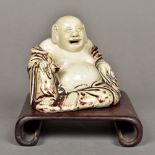 A Chinese blanc de chine porcelain Buddha Modelled seated holding a fruit,