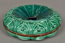A 19th century majolica spitoon The central well bordered by acanthus fronds. 21 cm diameter.