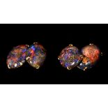 A pair of 14 K gold black opal mounted cufflinks Each of double cabochon form. Each 2.25 cm high.