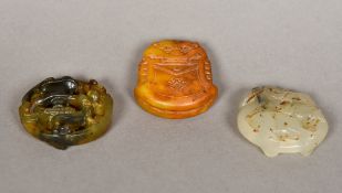 Three Chinese jade roundels Each carved with mythical beasts. The largest 5.5 cm diameter.