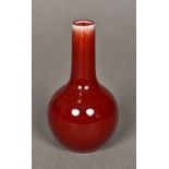 A small Chinese sang de boeuf porcelain vase Of ovoid form, with elongated neck,
