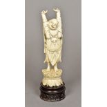 A Chinese carved ivory Buddha Modelled standing with arms outstretched,