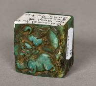 A Chinese carved turquoise and russet jade seal Worked with a temple lion and crane,