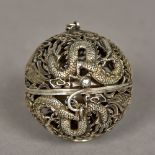 A Chinese white metal pendant incense burner Of pierced globe form, worked with dragons,