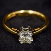 An 18 ct gold diamond solitaire ring The princess cut claw set stone approximately 0.