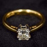 An 18 ct gold diamond solitaire ring The princess cut claw set stone approximately 0.