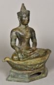 An Eastern cast bronze figure of Buddha Modelled in Bhumisparsa, seated on a navette form cushion,