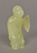 A Chinese carved jade figure of Buddha Modelled standing in a robe. 8 cm high.
