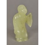 A Chinese carved jade figure of Buddha Modelled standing in a robe. 8 cm high.