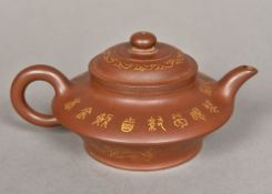 An 18th century Chinese Yixing pottery teapot Gilt decorated with landscape vignettes,