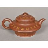 An 18th century Chinese Yixing pottery teapot Gilt decorated with landscape vignettes,