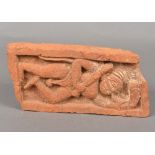 An antique Indian red pottery brick Relief moulded with a male figure blowing a horn. 24 cm wide.