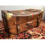 A vintage leather travelling trunk Set with brass corners plates and with red and green painted