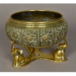 An Eastern bronze bowl on stand The main body decorated with scrolling bird filled vignettes,