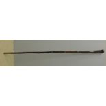 An 18th century Chinese bamboo staff The top with a turned wooden knop. 175 cm high.