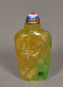 A Chinese carved green and russet jade snuff bottle The stopper enamelled. 5.5 cm high.