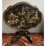 A 19th century mother-of-pearl inlaid chinoiserie tilt top centre table The hinged serpentine oval
