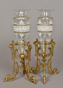 A pair of Victorian gilt and enamel decorated clear cut glass vases Each mounted on a mask and