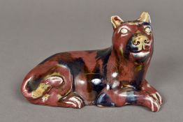 A Chinese porcelain group Modelled as a recumbent dog with allover mottled glaze. 19 cm wide.