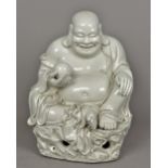 A large Chinese blanc de chine porcelain figure of Buddha Modelled seated holding a pearl,