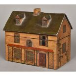 A 19th century polychrome painted wooden tea caddy Modelled in the form of a rustic cottage,
