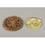 Two carved and pierced jade roundels One worked with mythical beasts flanking an ewer,